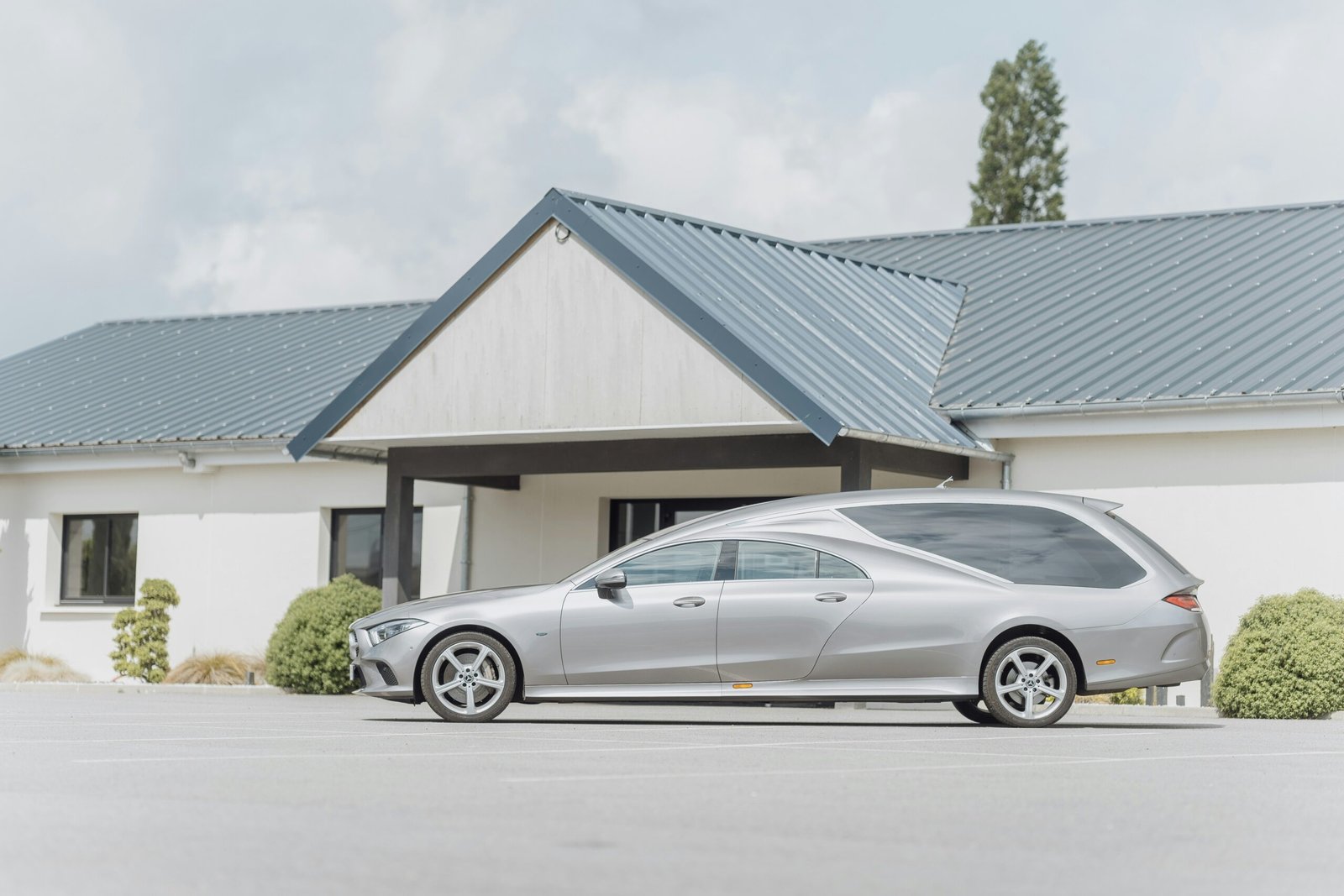 a silver car parked in front of a house